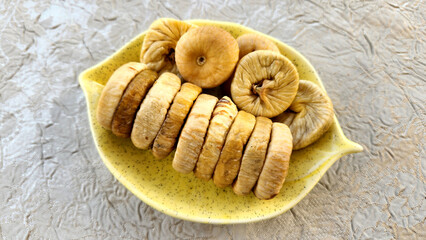 Sun dried figs in a snack bowl for eating on table