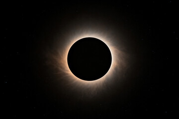 Total solar eclipse with visible corona against dark sky