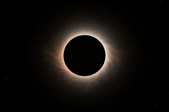 Total solar eclipse with visible corona against dark sky