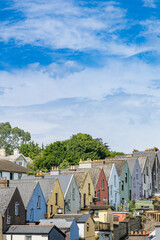 A stunning view of the iconic colorful houses in Cobh, Ireland. These vibrant row houses create a picturesque scene against the backdrop of this charming coastal town.