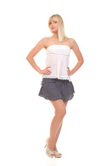 Blonde woman in summer outfit posing on white background