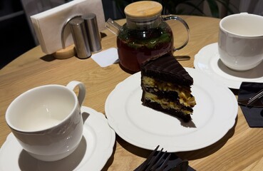  cake dessert accompanied by a cup of coffee on the table. Favorite delicious coffee cake. Cup of espresso coffee