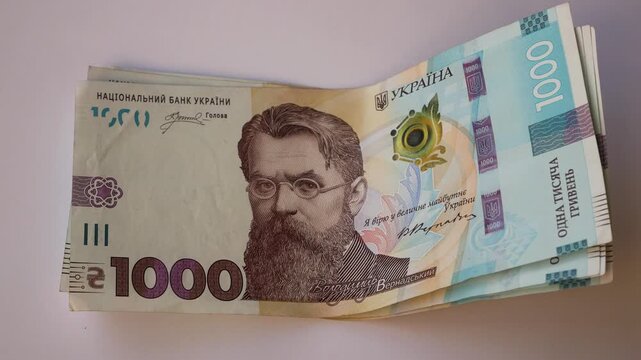 Banknotes with a face value of one thousand Ukrainian hryvnias lying on the table. Concept of national currency, finance, inflation, price growth and economy.