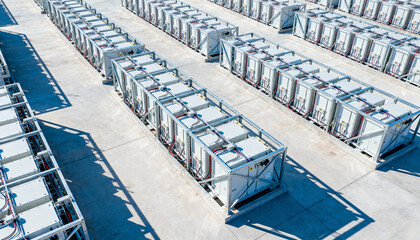 Aerial view of a Battery Energy Storage System BESS power station. Renewable sustainable green energy concept. Industrial container for electricity storage from solar and wind technology.