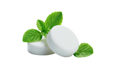 Two round, white, peppermint lozenges with fresh green leaves