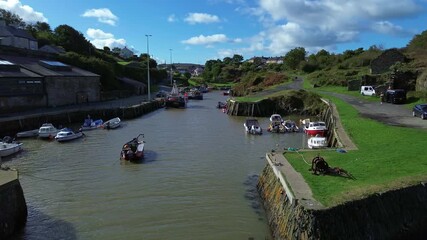 Amlwch harbour aerial view over boats moored on sunny sparkling Welsh town port waterway