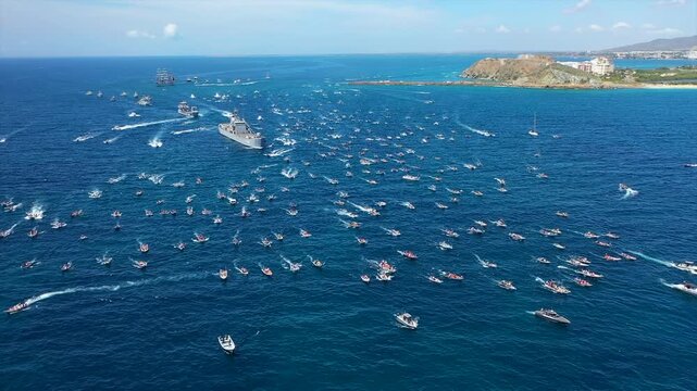 Aerial view of Virgen del Valle procession, boats on sea, vibrant faith display