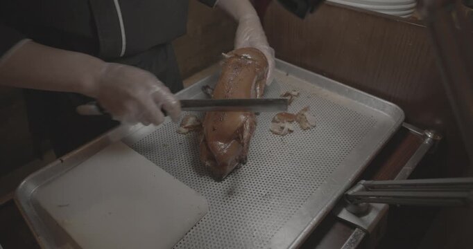 Roasted Peking duck dish being prepared for serving to guests