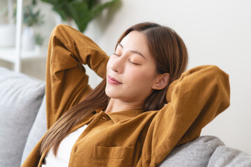 Young woman enjoying mind free moment relax and calm on the sofa at home.