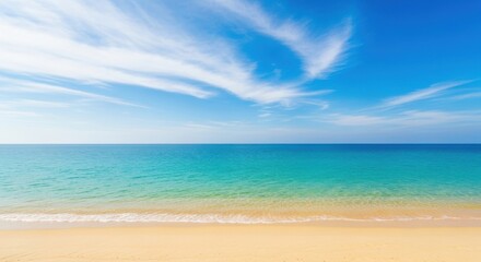 Fototapeta premium Serene beach landscape with turquoise ocean and wispy clouds under blue sky