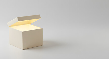 Obraz premium Open white gift box glowing from inside on light background 