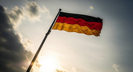German Flag Waving Proudly Against a Cloudy Sky.