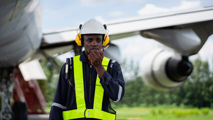 Fototapeta premium Aircraft maintenance engineer inspecting airplane engine with safety equipment and tools, aviation mechanic ensuring aircraft repair, safety check, and technical engineering service.