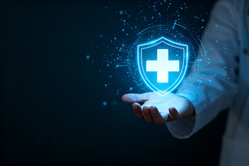 A person in a lab coat holds a glowing digital shield with a medical cross, symbolizing healthcare protection and technology.