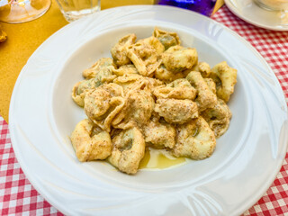 Raviolis with wallnut sauce served on a table