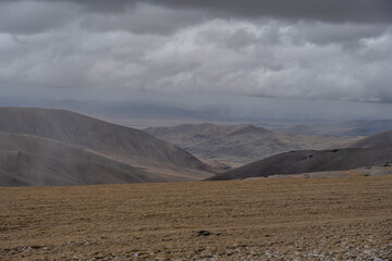 A beautiful landscape with mountains and autumnal yellow trees in the Altai Mountains.