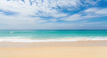 Obraz premium Serene tropical beach with turquoise water and wispy clouds on a sunny day