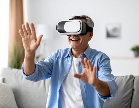 Happy senior man wearing virtual reality headset glasses, exploring immersive digital world from the comfort of his home