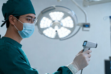 Surgeon in operating room holding a medical device