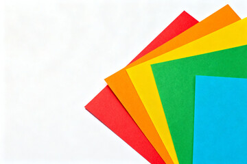 Stack of colorful paper sheets arranged in a fan-like pattern on a white background