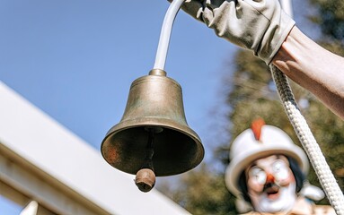 Clown ringing a bell at a festive event