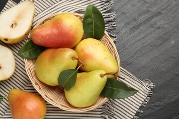Many fresh pears and leaves on black table, flat lay