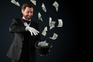 Magician performing trick with money flying out of hat against black background © New Africa