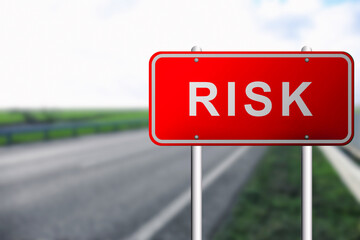 Red road sign with word Risk outdoors
