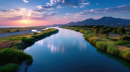 Vibrant River Valley at Sunrise with Golden Light and Lush Green Vegetation Under a Blue Sky with White Clouds in a Cinematic HDR Landscape