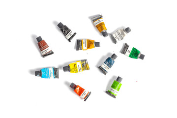 Indonesia,Sukoharjo - September 27,2025 : collection of used colorful watercolors packaged in a small bottle isolated on a white background