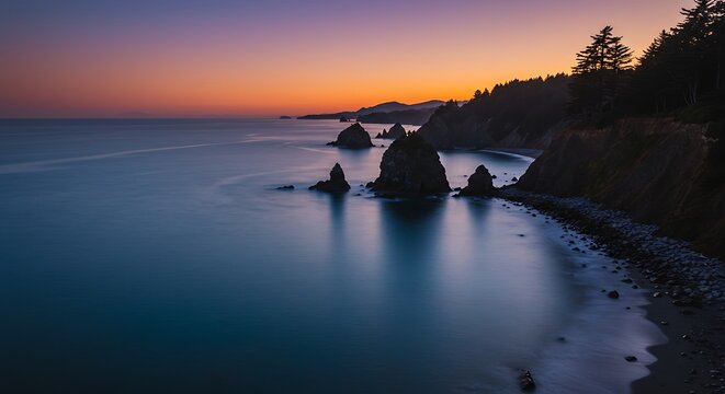 Coastal seascape at sunset tranquil water and silhouette rock formations