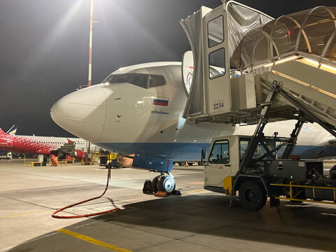 Pobeda Airlines after flight at Pulkovo international airport in St.Petersburg at night. Airplanes at Pulkovo international airport. Pobeda Airlines Boeing 737. 