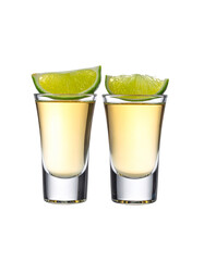Two shot glasses of tequila with lime slices