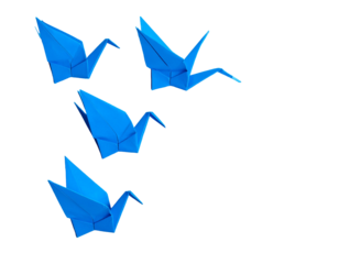 Four origami cranes in vibrant blue