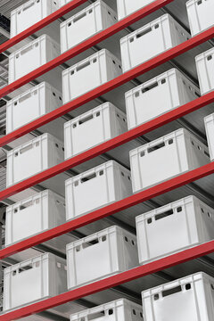 Generic white unlabeled boxes and crates on shelves of a warehouse rack