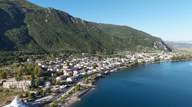 Aerial View of Kamena Vourla Coastline with Blue Waters and Mountain Backdrop