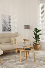 Stylish living room with lamp, houseplant and sofa. Interior design