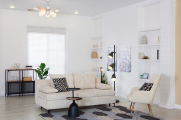 Stylish living room with lamp, houseplant and sofa. Interior design