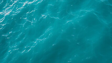 Fototapeta premium Aerial view of turquoise ocean waves forming abstract patterns, embodying a minimalist summer seascape.