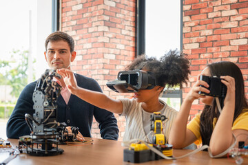 Teacher Supervising Students Using VR Headset and Robotic Kit in STEM Class, Children Engaging with Virtual Reality and Robotics, Diverse Students in a Technology and Engineering Workshop