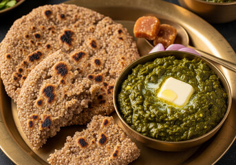 Traditional Indian Bajra Roti and Sarson ka Saag with Ghee and Jaggery on Brass Plate