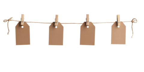 Blank cardboard tags hanging on string with wooden clothespins
