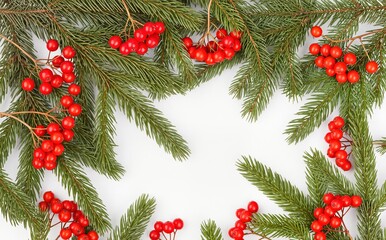 A beautiful arrangement of green pine branches adorned with vibrant red berries, perfect for holiday decor.