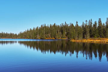 Fototapeta premium Vestre Ormtjernet Lake from the Svartdalstjerna Primeval Forest Nature Reserve of the Totenåsen Hills, Norway, in September 2025.