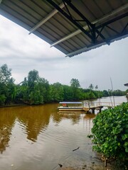 Peaceful Riverside Boat Dock With Calm Bongawan River