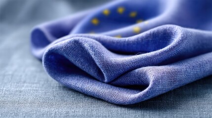 Detailed View of European Union Flag on Textured Fabric with Gold Stars and Blue Textile Backdrop