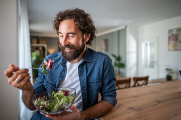 Happy man enjoying fresh healthy salad for lunch