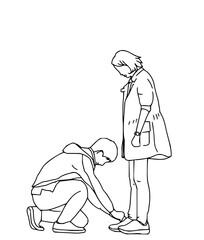 Fototapeta premium Caring man gently ties partner's shoelace showing affection and support in a moment of tenderness