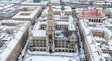 Obraz premium Aerial view of Munichs snow-covered city hall.