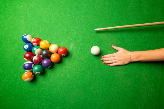 a woman playing billiard top view